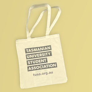 A beige tote bag with the text "TASMANIAN UNIVERSITY STUDENT ASSOCIATION" and "tusa.org.au" printed in bold black letters.