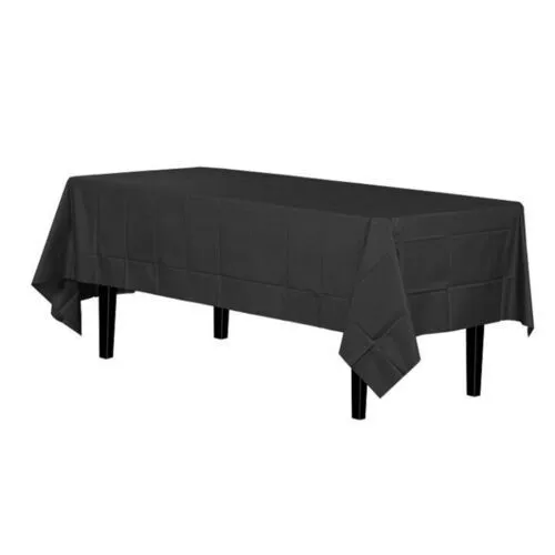 A rectangular table covered with a plain black tablecloth, positioned against a white background.