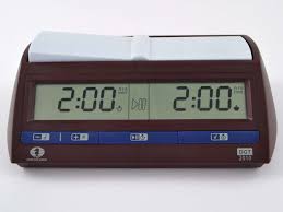 A digital chess clock displaying 2:00 on both screens, with blue control buttons and a dark brown casing.