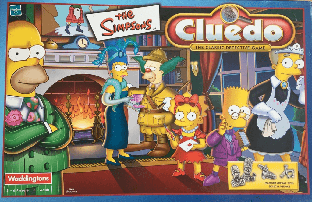 The Simpsons-themed Cluedo board game box showing Simpson family characters dressed as classic detectives in a mansion setting, with game pieces displayed in the corner.