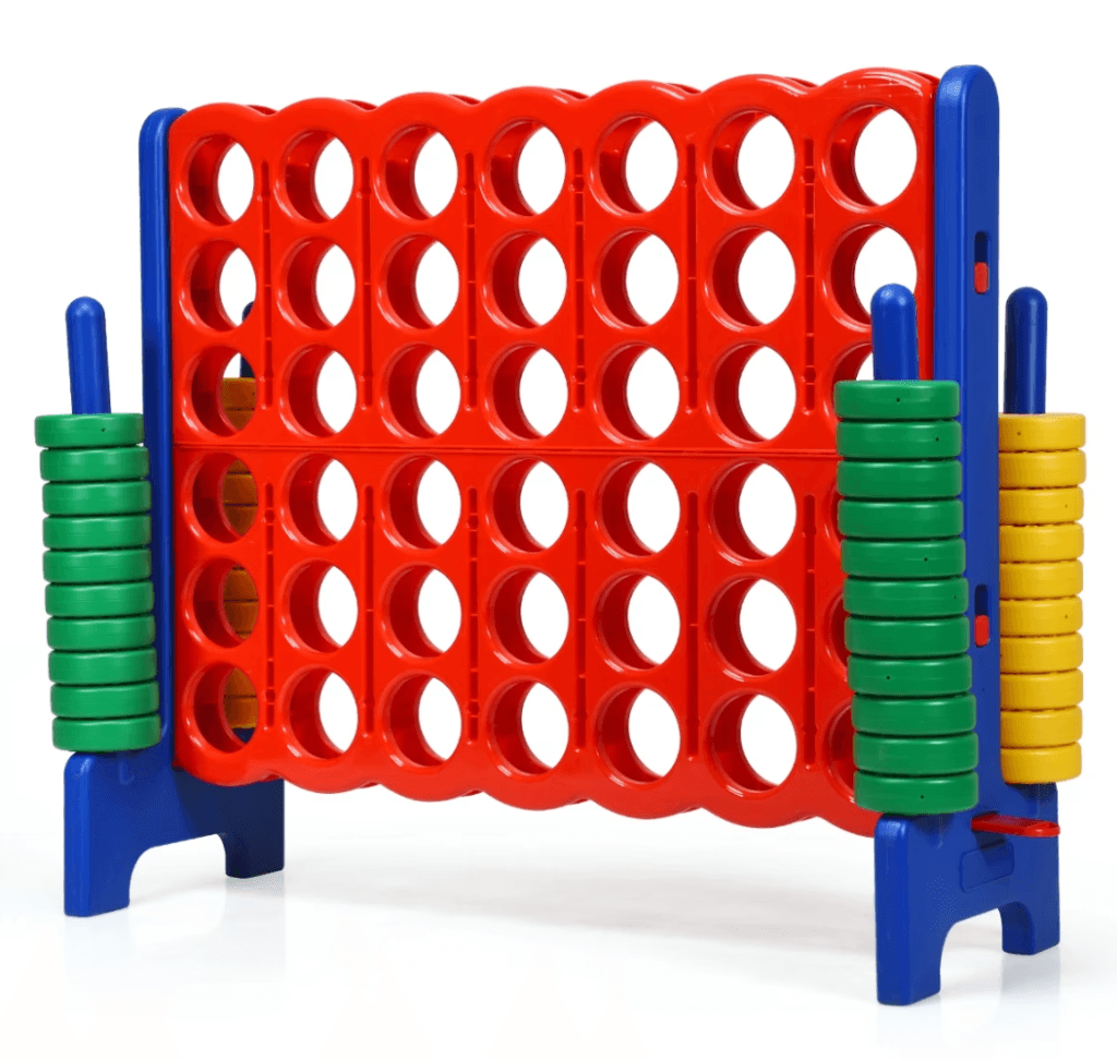 A large plastic Connect Four game with a red grid, blue frame, and two stacks of green and yellow counters on each side.