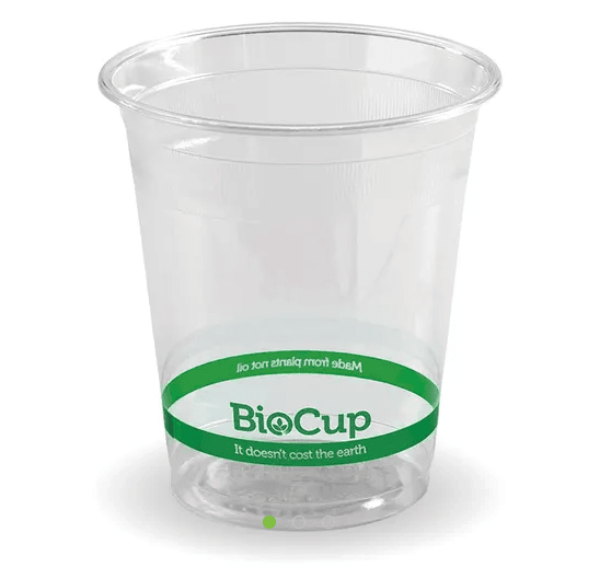 A clear plastic cup labeled “BioCup” with green text stating “It doesn’t cost the earth” and a green band around the middle.